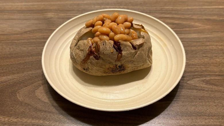 baked potato with baked beans on plate