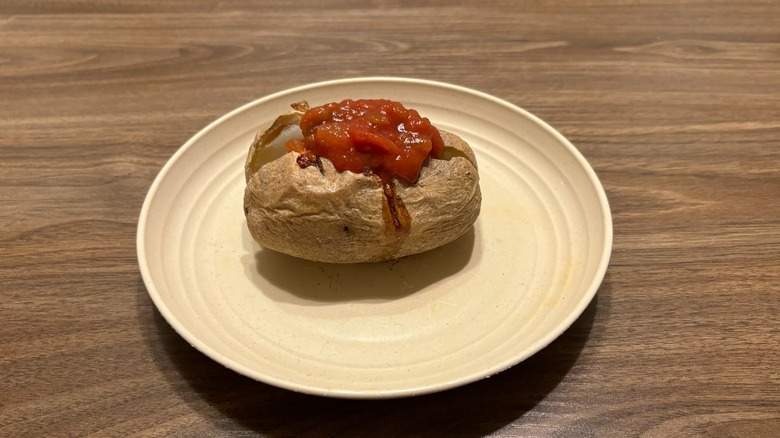 baked potato with salsa on plate
