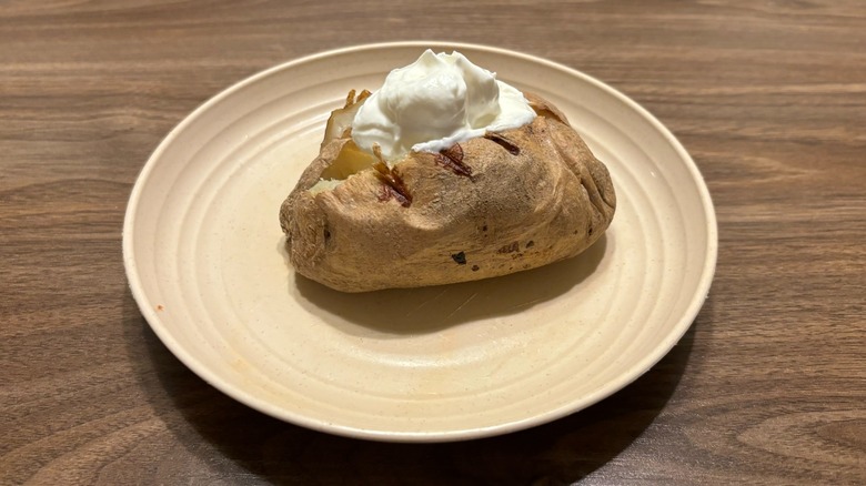 baked potato with sour cream on plate