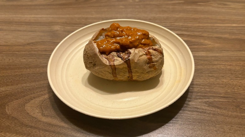 baked potato with chili on plate