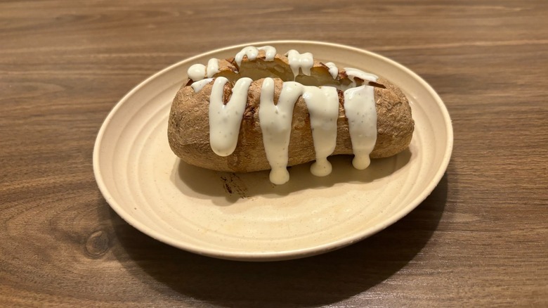 baked potato with ranch on plate