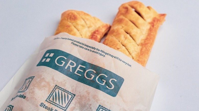 Greggs sausage roll in a takeaway bag
