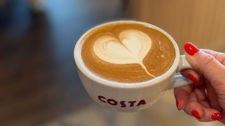 a cup of Costa Coffee with a cream heart