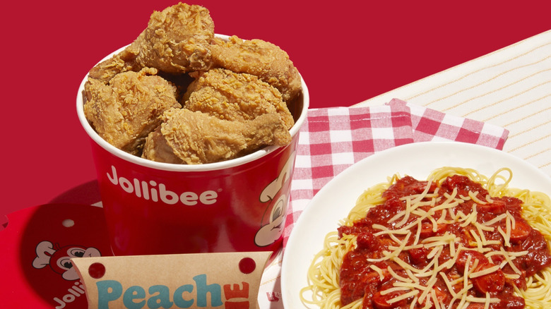 Jollibee bucket of chicken, Peach Mango Pie, and plate of spaghetti