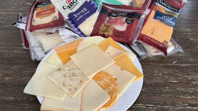Cheese slices on white plate with packages in the background