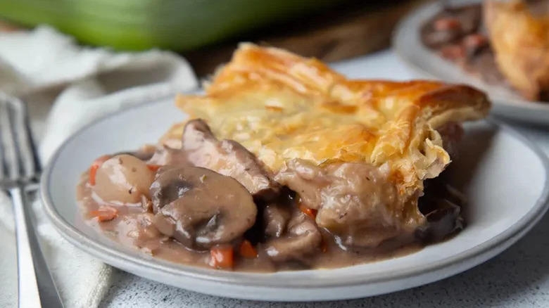 An individual serving of mushroom pot pie on a plate