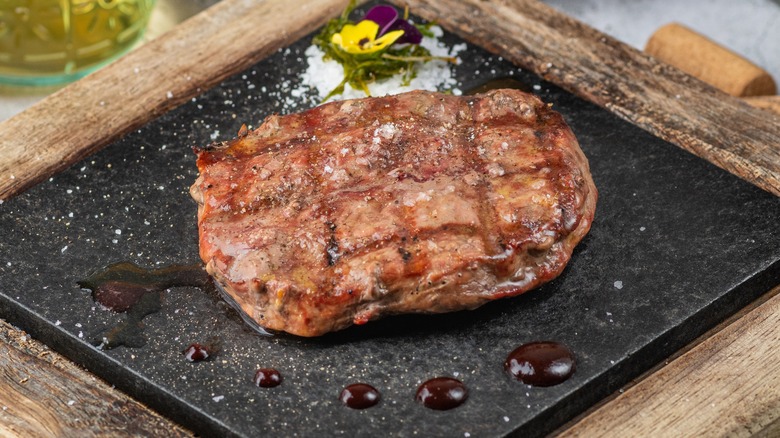 Chicago style steak on black plate