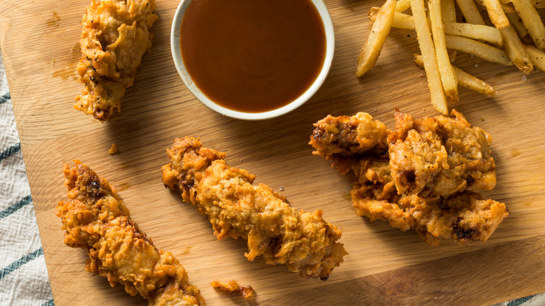 Idaho finger steaks with fries and dip on wooden board
