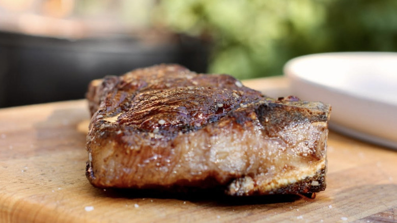 cooked Kansas City strip on wooden board