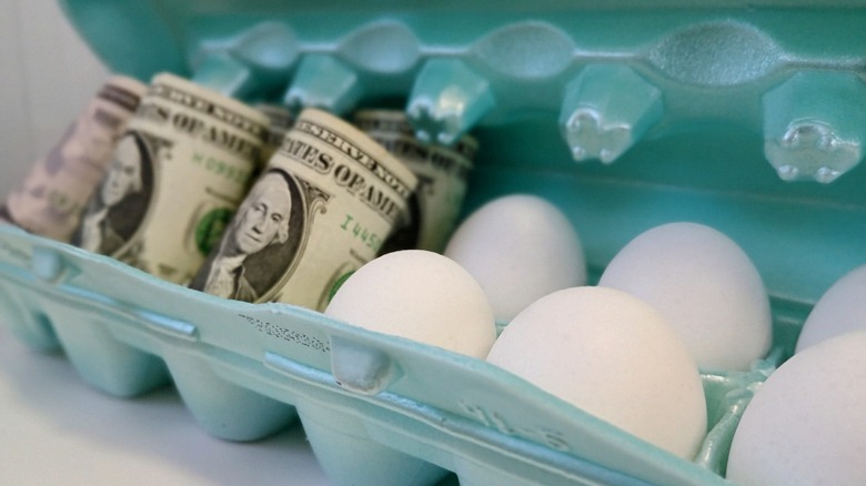 High price of eggs concept with dollar bills with eggs in egg carton