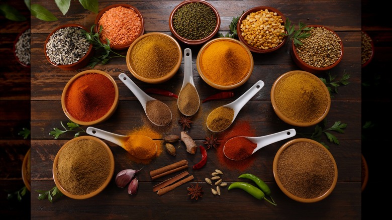 A selection of herbs and spices including Red and Green Chilli Turmeric Cumin Garam Masala making for savory cuisine