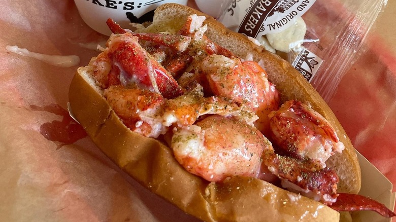 A Luke's Lobster roll, with pieces of cooked lobster inside a brioche bun.