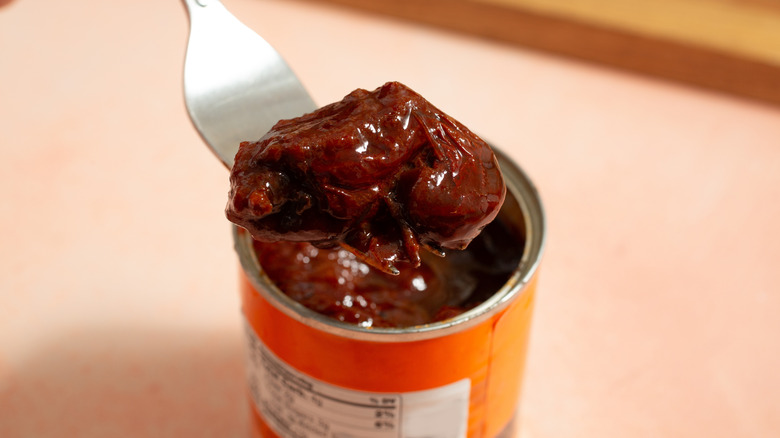 Fork lifting chipotle chile out of can