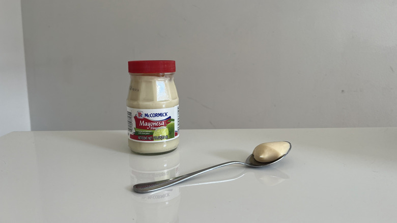 A jar of McCormick mayonnaise resting on a white table