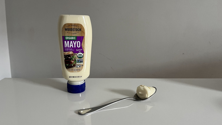 A squeeze bottle of Woodstock mayonnaise on a white table