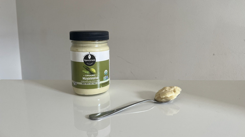 A jar of Spectrum Organic mayonnaise placed next to a spoon