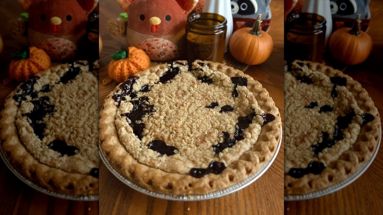 A concord grape pie on wooden counter