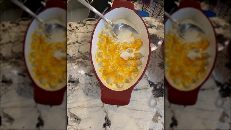 Creamed onions in casserole dish with spoon