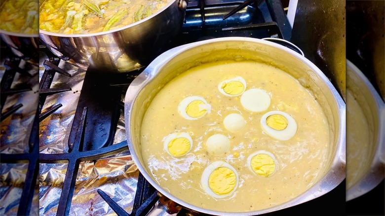 Pan full of giblet gravy topped with sliced hard boiled eggs