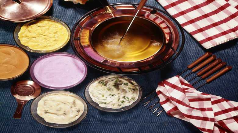Retro fondue set on a blue tablecloth