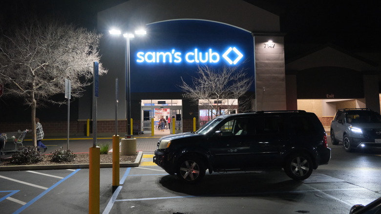 Front entrance of Sam's Club and parking lot at night