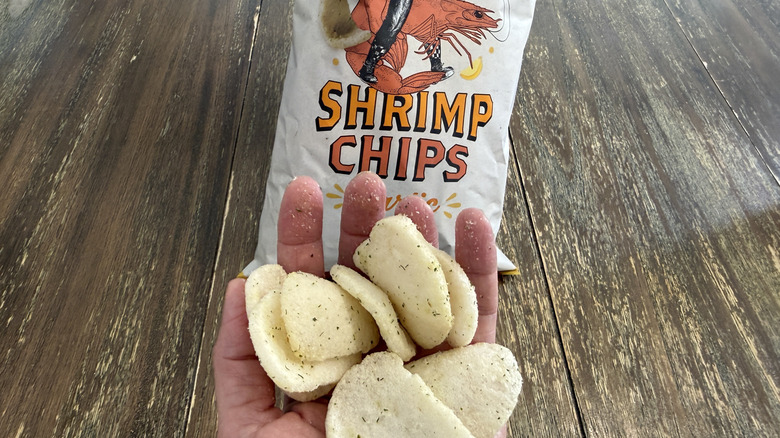 Trader Joe's Shrimp Chips on wooden table and a handful of them
