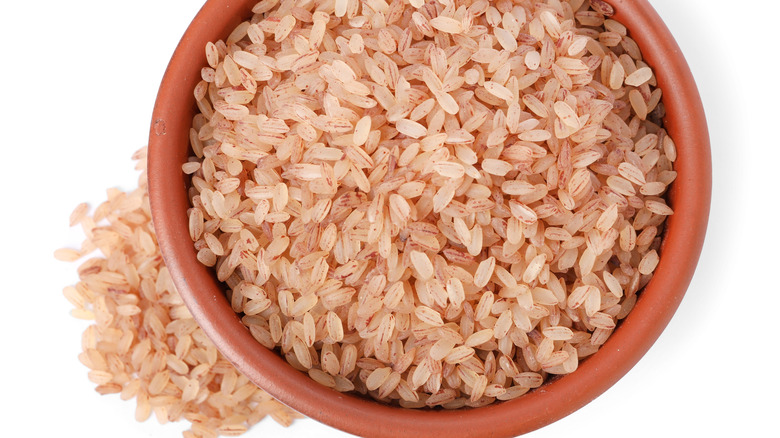 Raw organic matta rice in a red bowl