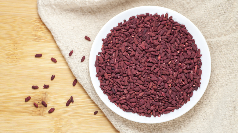 Red rice in a white ceramic dish