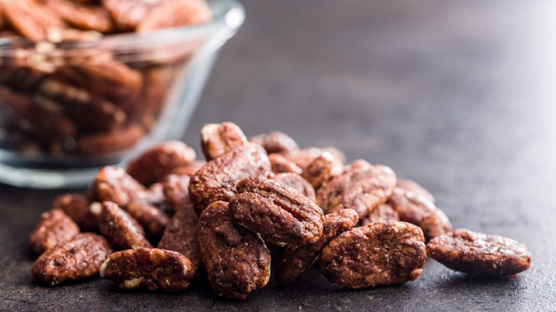 candied pecans on black surface