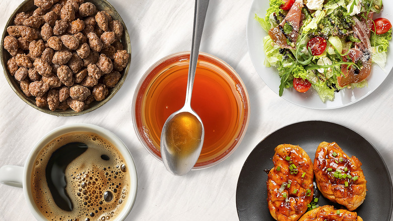 bowl of maple syrup with three plates of food and cup of coffee