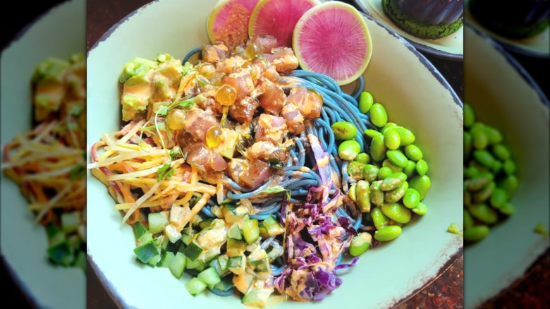 A brightly colored bowl of noodles and vegetables