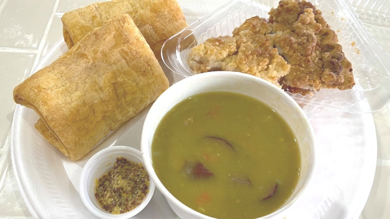 Split pea soup, Dutch apple pie, and fried croquettes arranged on a white plate