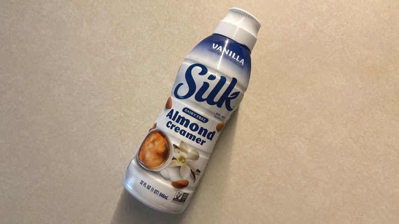 Silk Dairy-Free Vanilla Almond Coffee Creamer bottle on counter