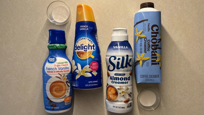 vanilla creamer bottles on counter with small glasses filled with creamer