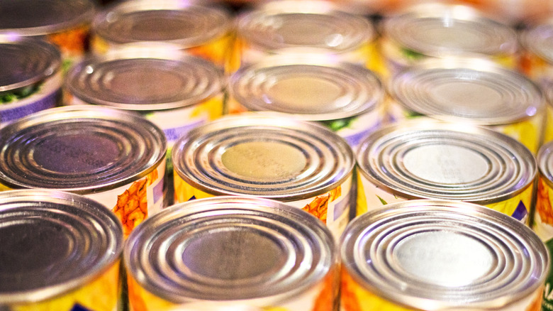 rows of canned foods with yellow labels