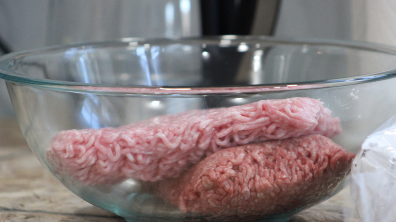 raw ground beef in glass bowl on kitchen counter