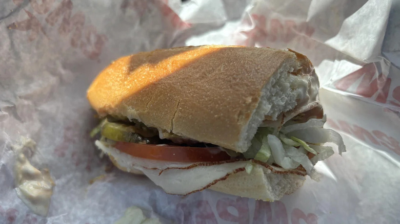 Junior size hoagie with turkey, tomato, shredded lettuce, and dressing from Wawa in paper