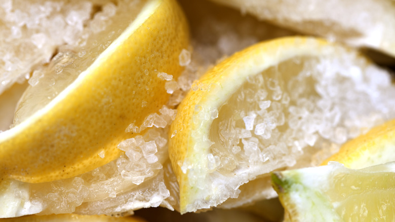 Freshly cut lemons covered in salt