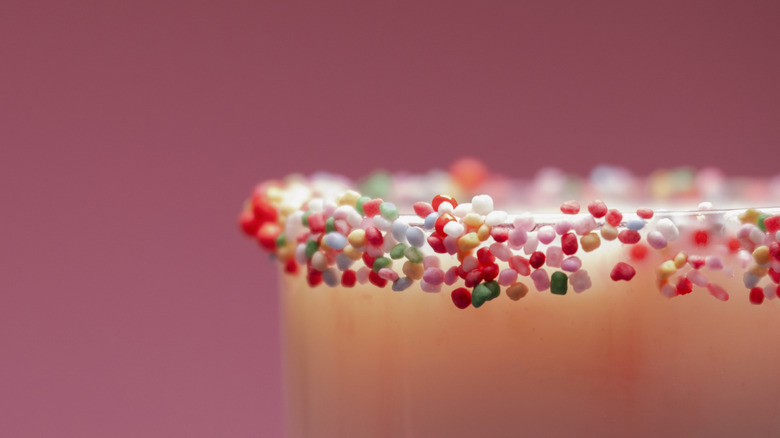 Colorful sprinkles on a glass rim