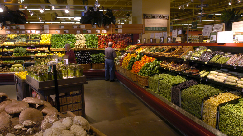 Two shoppers selecting produce at a Whole Foods Market
