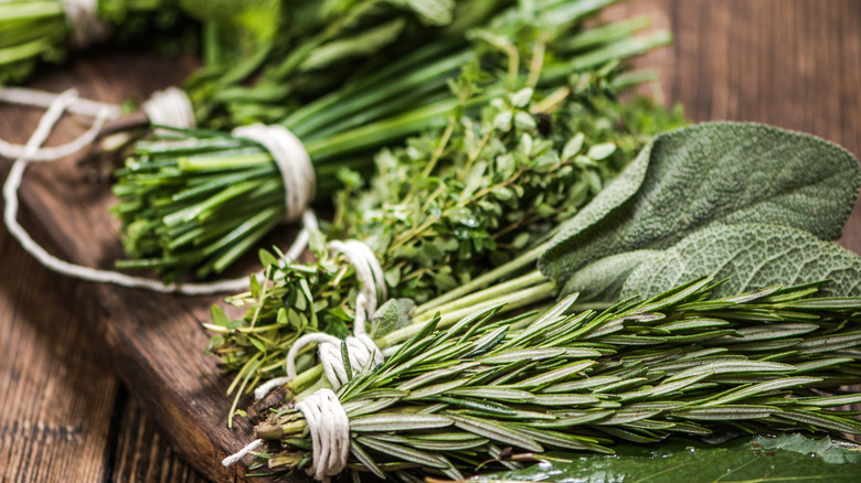 Up close view of freshly cut herbs on a wood table
