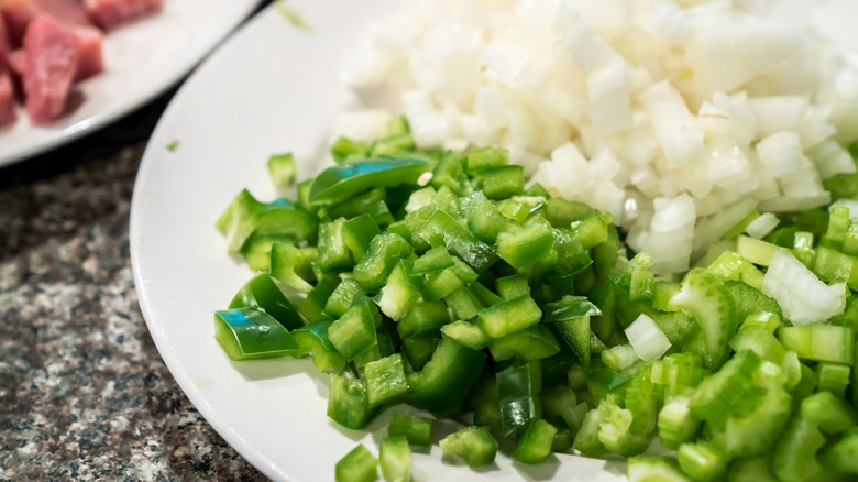 Chopped celery, onion, and bell pepper on a plate