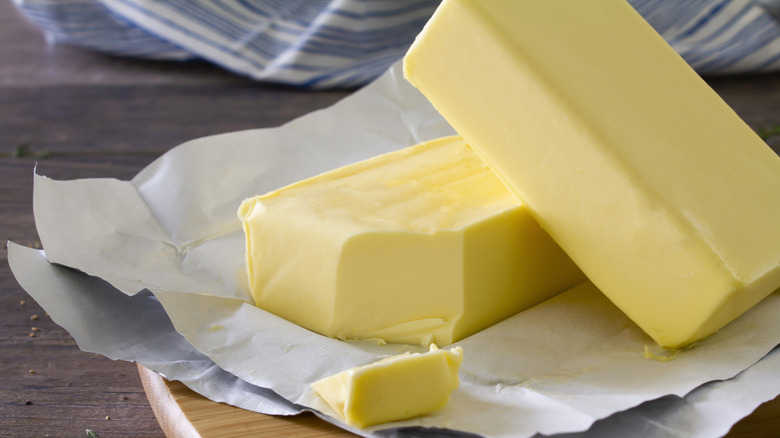 An up-close view of two sticks of butter on paper