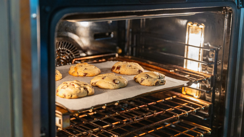 Homemade chocolate chip cookies baking in an oven