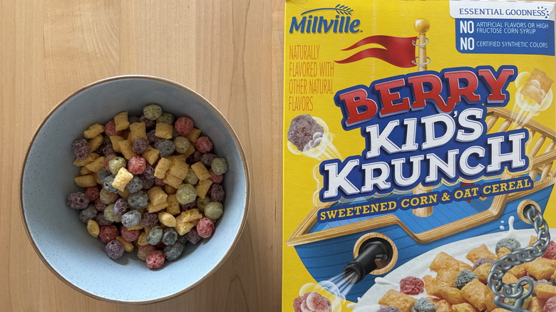 A bowl of colorful cereal next to a box of Berry Kid's Crunch