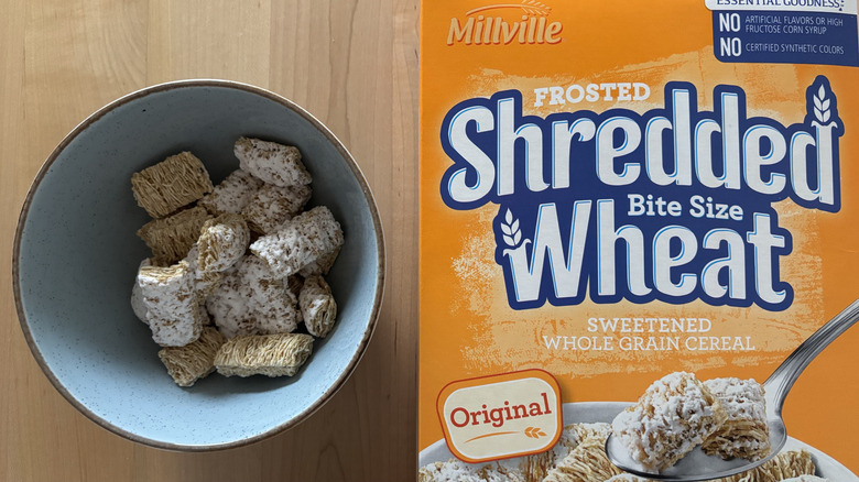 A bowl of Frosted Shredded Wheat cereal next to box of Frosted Bite Size Shredded Wheat