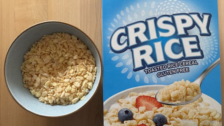 A bowl of rice cereal next to a box of Crispy Rice