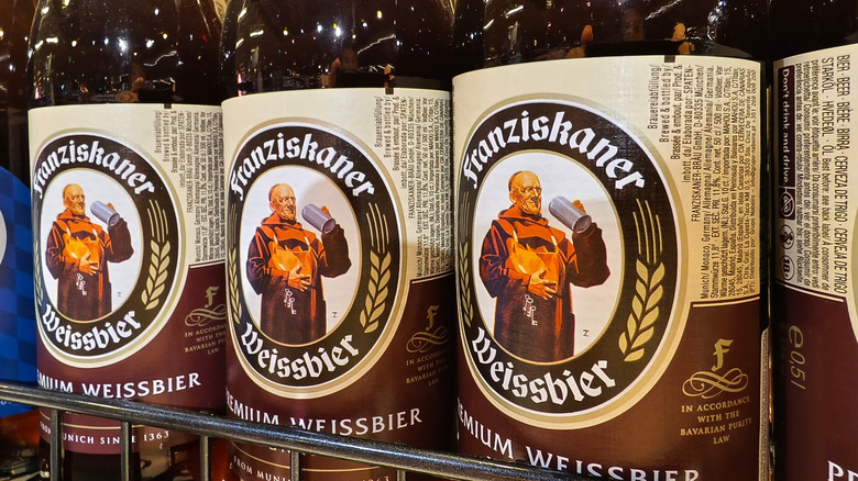 A close-up on a rack of Franziskaner Premium Weissbier bottles with logo visible