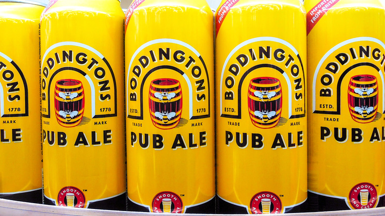 A close-up on yellow nitro cans of Boddington's Pub Ale