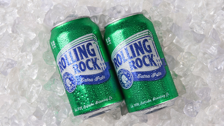 Two cans of Rolling Rock beer on a bed of ice